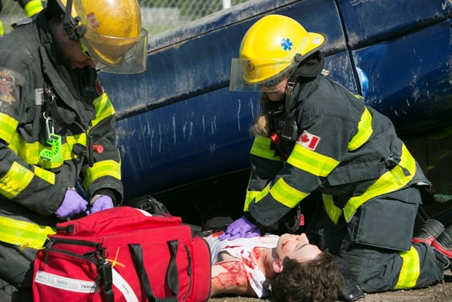 Sundre firefighter Nicole Toth performs CPR on Daniel Corbett, who played Friday, May 13 the role of a deceased victim in a staged collision scenario designed to demonstrate