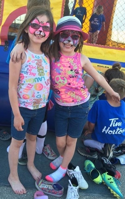 SUNDRE DAYCARE CENTRE CELEBRATES END OF YEAR — Sierra and Skye Rosvold are all smiles after getting their faces painted as they patiently wait their turn to hop around in a
