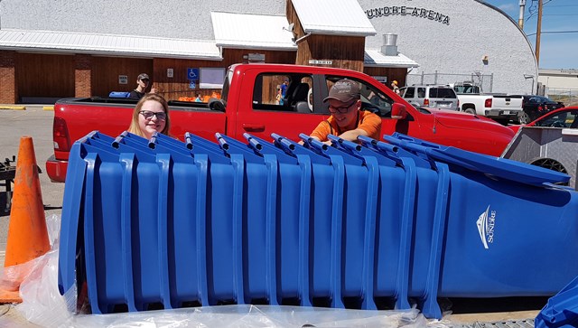 ROLLING OUT THE RECYCLING BINS — Sundre High School students Aleah McClendon and Brady Wescome were among several young volunteers who helped on Saturday, June 4 to roll out