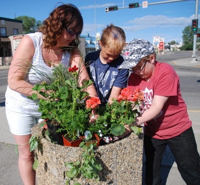 A group of Grade 4 students from River Valley School spent some time during the morning of June 9 planting flowers in Main Avenue&#8217;s planters. Pictured here from left