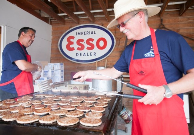 Coun. Chris Vardas, left, and Mayor Terry Leslie cook up hamburgers during the free barbecue hosted by town officials during last year&#8217;s Canada Day celebration.,