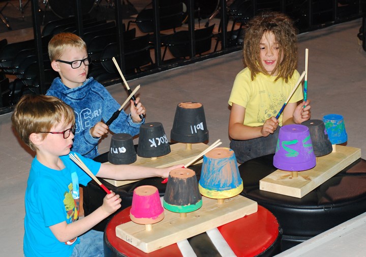 DRUMMING TO THE BEAT — From left, Leif Sande, Caige Anderson and James Main have fun on Thursday, July 7 playing the &#8220;potophones&#8221; they made during the week-long