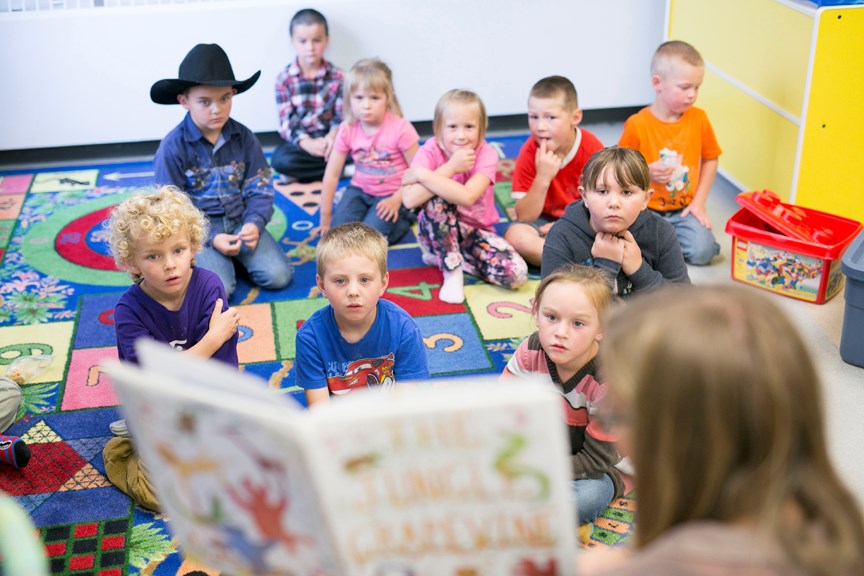 STORY TIME — Emily Plemel, the Sundre Municipal Library&#8217;s summer coordinator, reads a story to an attentive group of children during the recent summer program. Regular