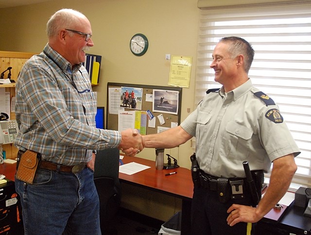 Const. Val Dennis, left, shakes hands in a fond farewell with the Sundre RCMP detachment&#8217;s commander Sgt. Jim Lank on Thursday, Sept. 29. Dennis initiated a transfer