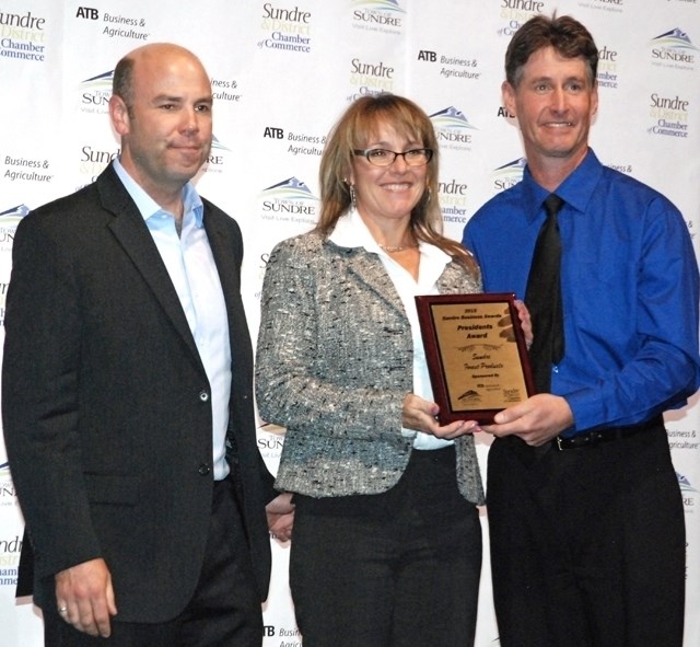 Mike Beukeboom, president of the Sundre and District Chamber of Commerce, right, presented the Presidents Award to Sundre Forest Products employees during last year&#8217;s