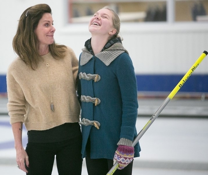 Olympic medallist Cheryl Bernard shares on Wednesday, Dec. 4 a moment with Sundre Junior Curling Club member McKenzie McElhinney.,