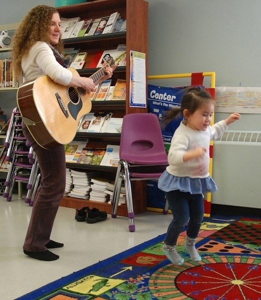 Keira &#8220;Kiki&#8221; Greenwood, 2, from Sundre, enthusiastically hops and bounces around during a musical portion of the Sundre Municipal Library&#8217;s Wiggles and