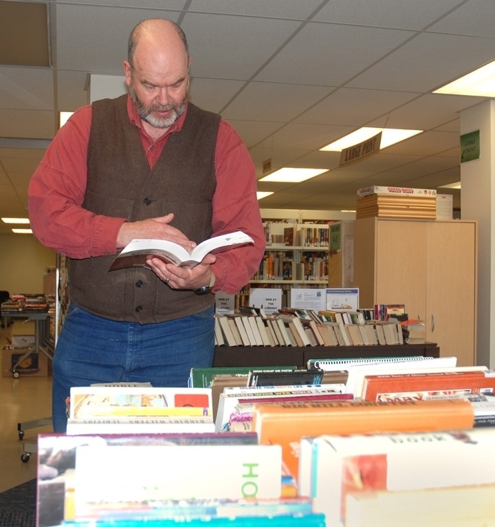 Sundre-area resident Rob Holland was perusing the many titles available at the Sundre Municipal Library last week during the annual Big Book Sale when a non-fiction book by