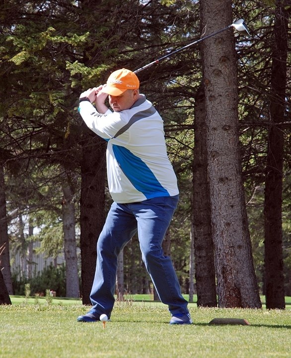 Local resident Arnie Gess, a member of the Sundre Golf Club for about 11 years, winds up to tee off at the course&#8217;s No. 1 hole for the first time of the season on