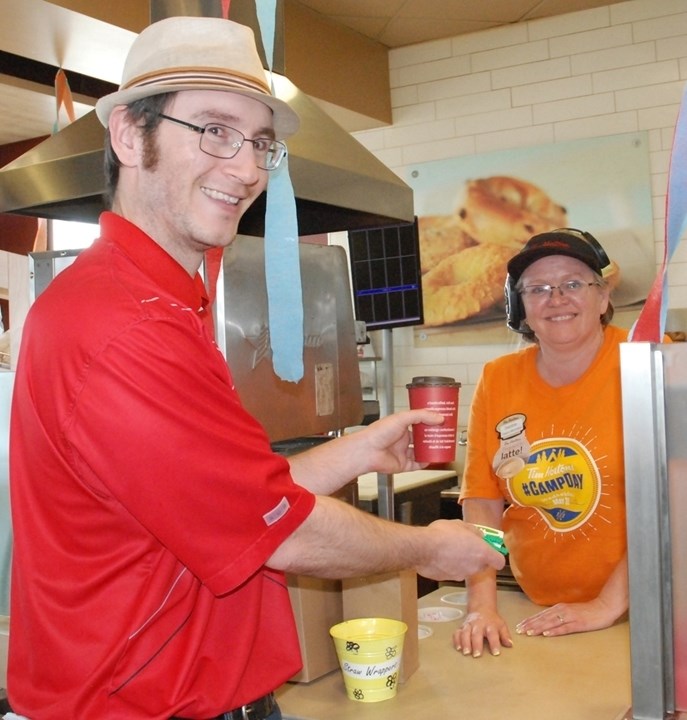 Sundre Tim Hortons employee Debbie Lausen serves the Round Up&#8217;s editor, Simon Ducatel, a latte on Wednesday, May 31 during an annual fundraiser that directs proceeds