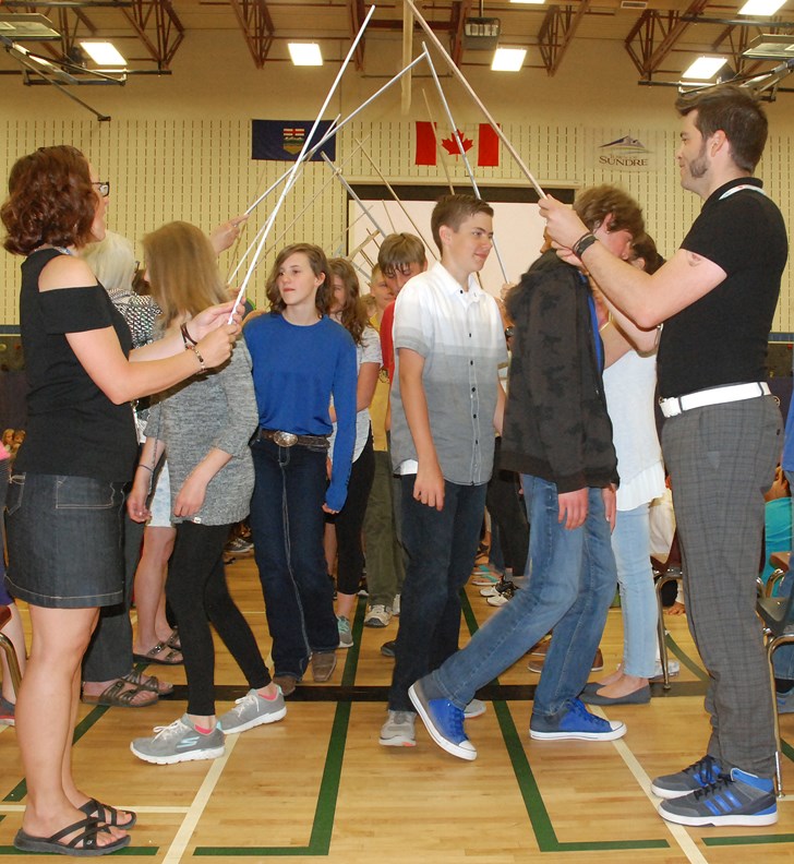 River Valley School Grade 8 students march under an archway of metre sticks held high by teachers and staff on the morning of Thursday, June 29 before the annual year-end