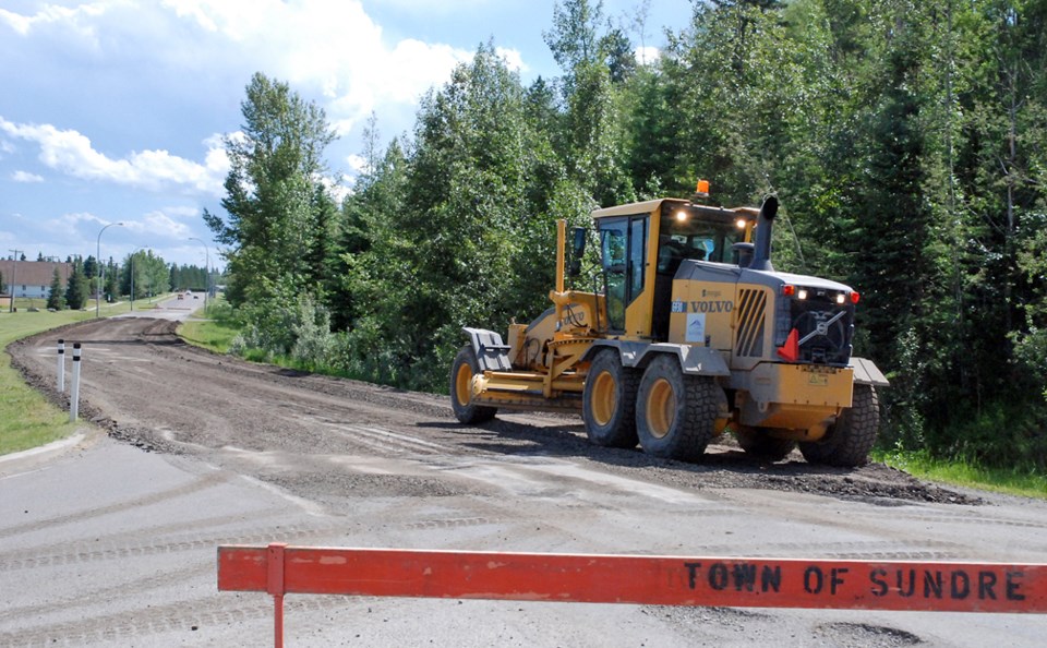 The Town of Sundre&#8217;s road crew tore up the surface of pothole scarred Centre Street North on Tuesday, June 27 to flatten out the road and lay gravel as a preliminary