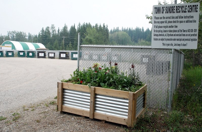 Sundre operations manager Jim Hall demonstrates the option to use compostable bags in a small plastic container for the kitchen. Once full, the bags can be tied up and sealed 