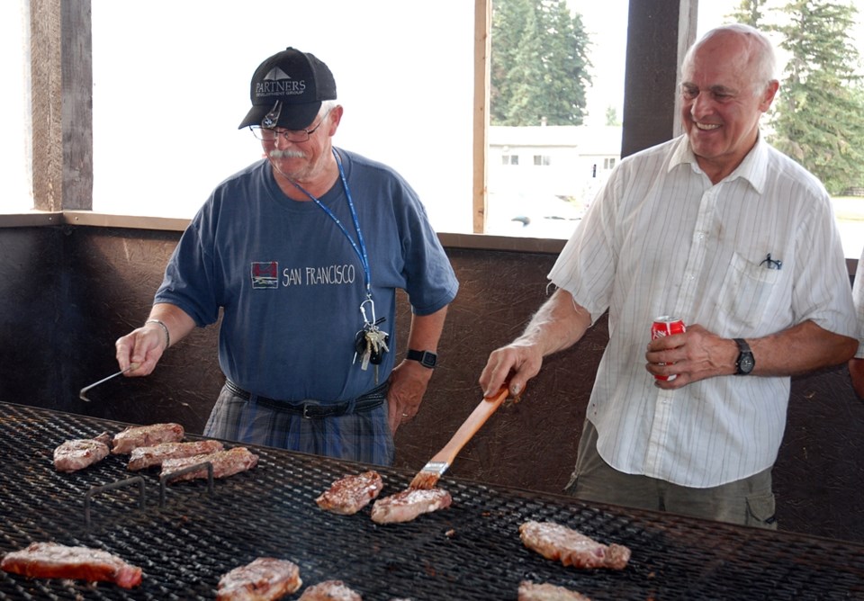 Eric Jackson, left, a Calgary resident who owns a recreational property at Tall Timber, and Dave Gerber, who lives southwest of Sundre, cook up some steaks at the Sundre