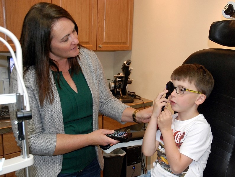 Dr. Tanya Sitter recently ran a routine eye exam on Lincoln Bruder, who started Grade 1 at River Valley School this year. As children spend more time on digital devices at