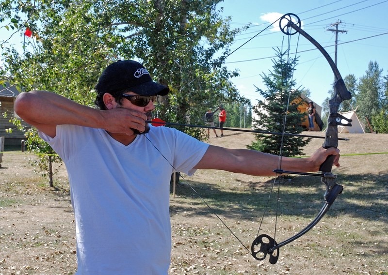 Tim Mearns, with Painted Warriors and Elkridge Archery, demonstrates how to safely draw and release an arrow on Saturday, Sept. 2 behind the Sundre Visitor Information Centre 