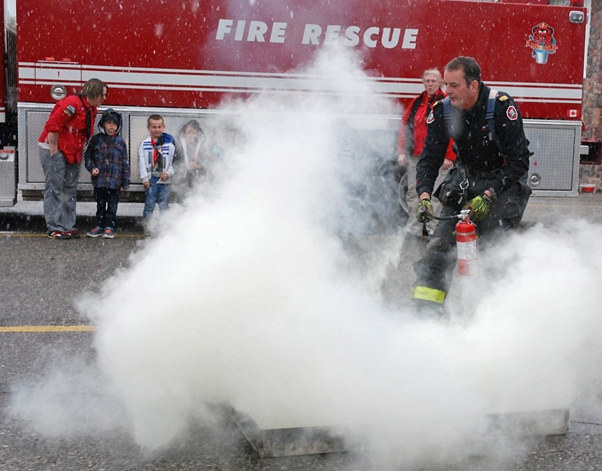 Frank Crouch, Sundre&#8217;s fire prevention officer, demonstrates to the First Sundre Colony Beavers last Wednesday, Oct. 11 how to safely use a fire extinguisher during