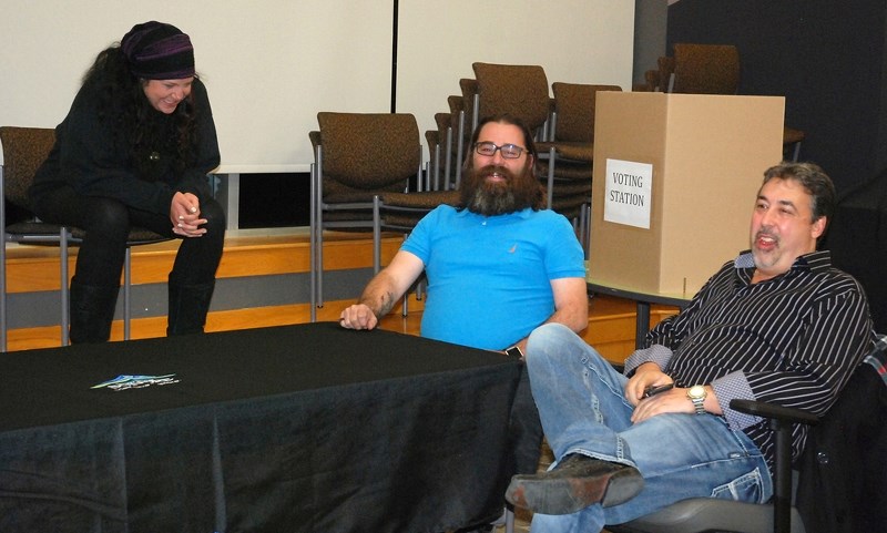 Council candidates Cheri Funke and Todd Dalke, middle, share a laugh with mayoral candidate Chris Vardas at the Town of Sundre&#8217;s municipal office last Monday night as