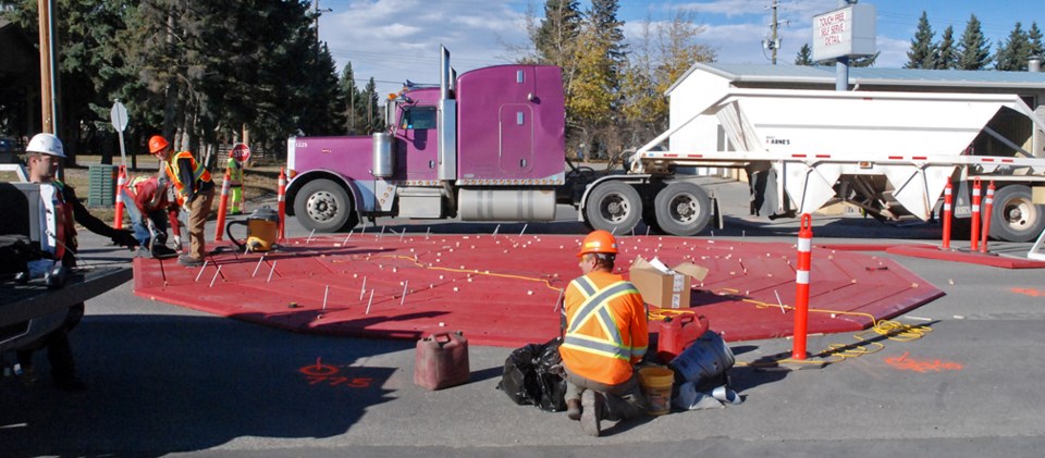 A construction crew was busy working on Main Avenue last Tuesday, Oct. 17 to install at the Fourth Street intersection the first of three mini roundabouts. The project has