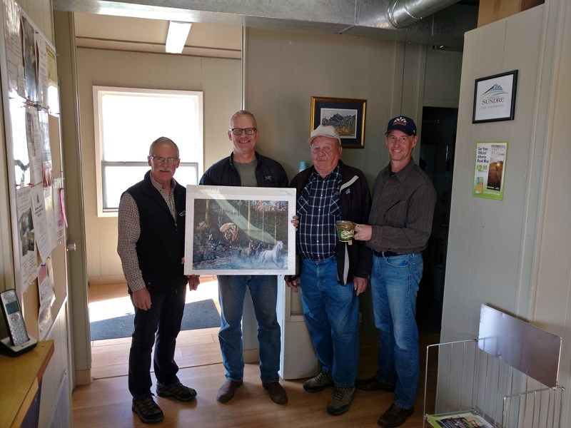 Calgary resident Gary Braun, second from the left, became the 5,000th person to sign the guestbook at the Visitor Information Centre, setting for the third year in a row a