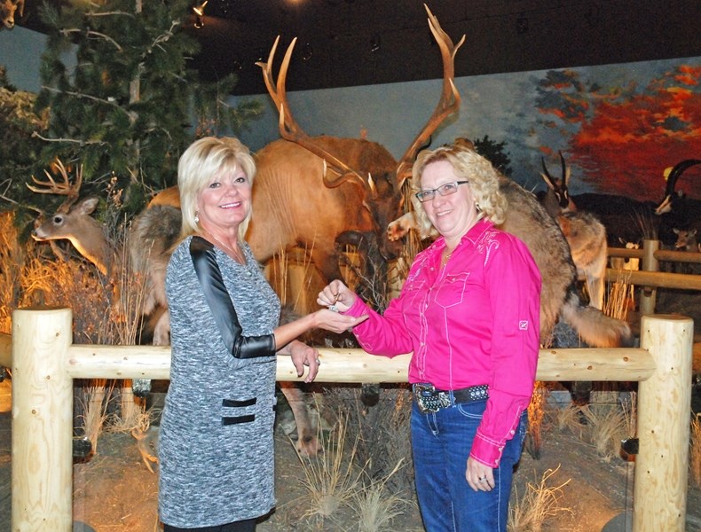 Tami Parkinson, left, the Sundre Pioneer Museum and World of Wildlife&#8217;s new manager, recently accepted the keys from outgoing manager Darlene Temple.