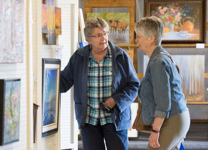 Joyce Brosinsky, left, and Fay Vickers visit during the event.