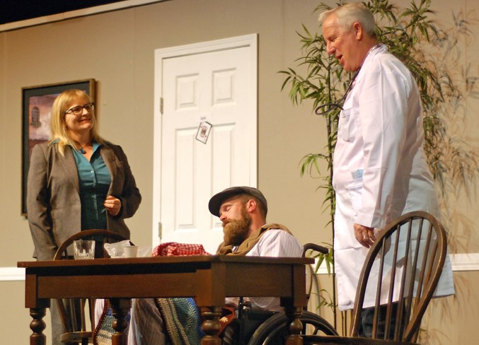  Nigel Miller, right, played the role of Jack, a former diamond salesman, who in this scene was posing as a doctor in an attempt to convince the conman’s lawyer Alice Mortimer, played by Julie Younglove, to stop from transferring the fraudulently “comatose” Barney, played by Keegan Smith, to another facility.