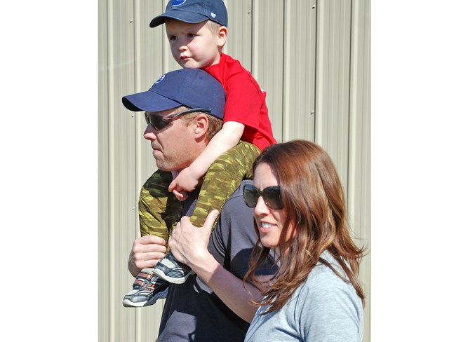  Cody Smith, Lisa McQuiston and Owen, 4, who came out from near Caroline, watch as a plane taxis back to the runway.