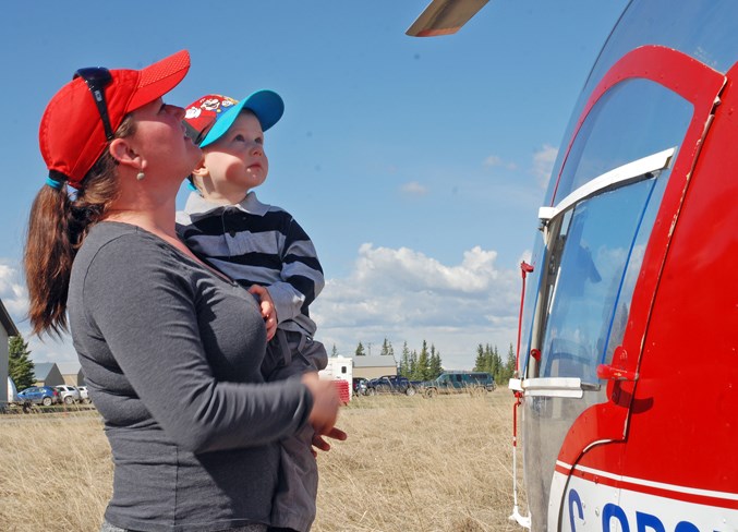  Aspen Muraski checks out with her son Levi, 2, a Bell helicopter, a model made famous by the television series MASH.