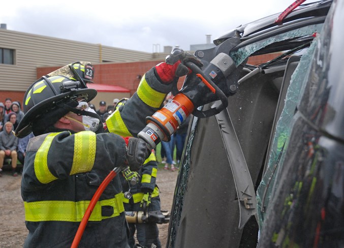  Sundre firefighter Ryan Martens operates the Jaws of Life the responders used to extricate the trapped driver, who was “arrested” for impaired driving after being pulled out of the wreck.