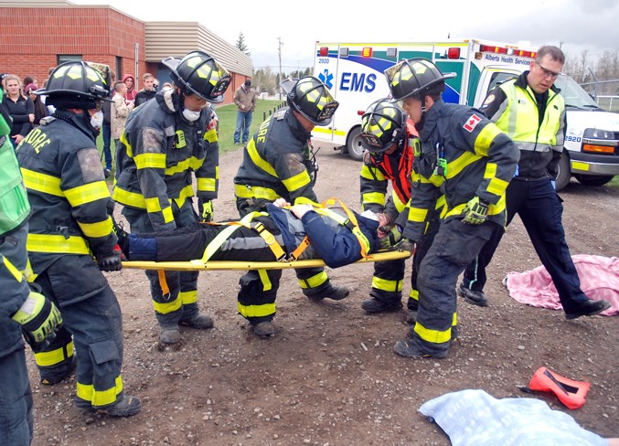  Sundre High School Drama Club student Gavin Beck played the role of the driver responsible for the staged crash, and was placed on a stretcher after being pulled from the crashed truck.