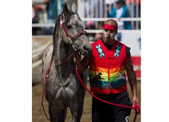  A competitor walks with a horse on Saturday afternoon before the start of the Indian relay race.