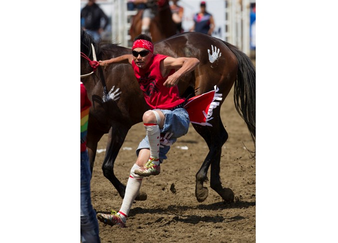  A competitor leaps off a horse during the Indian relay race.