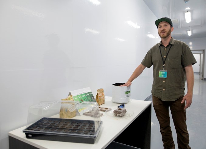  Master Grower Tyler Martens discusses details on growing procedures during a tour of the facility.