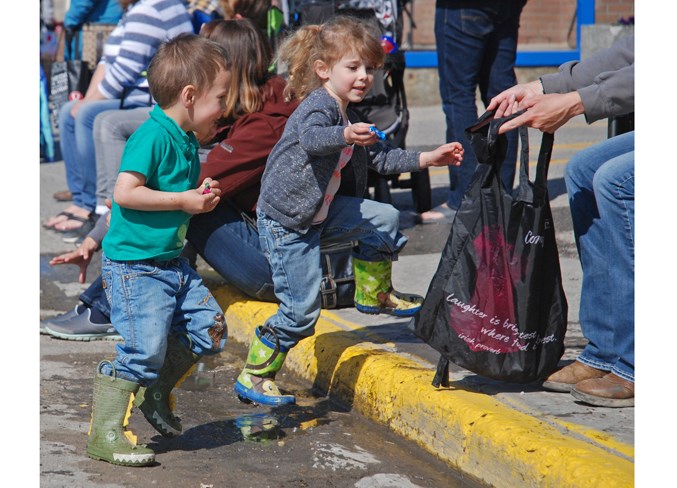  Stetson Cox, 2, and his sister Sierra, 4, were among many excited children enthusiastically scooping candy from the streets as the parade went by.