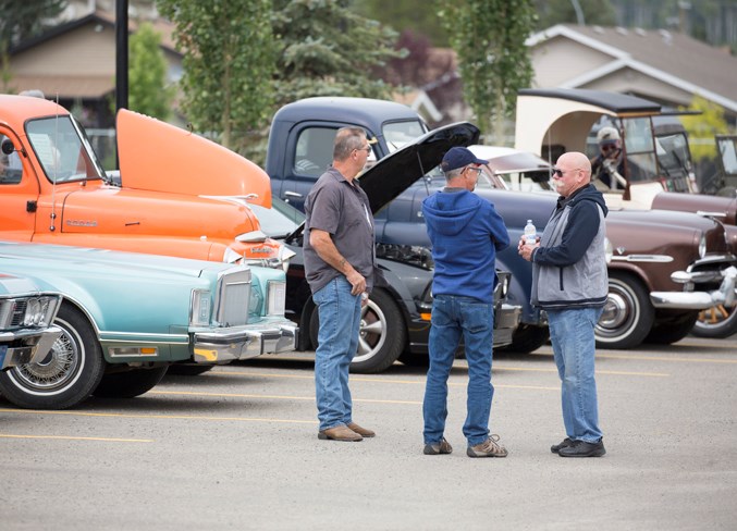  People browse through the vehicles on display during the event and enjoy the chance to chat.