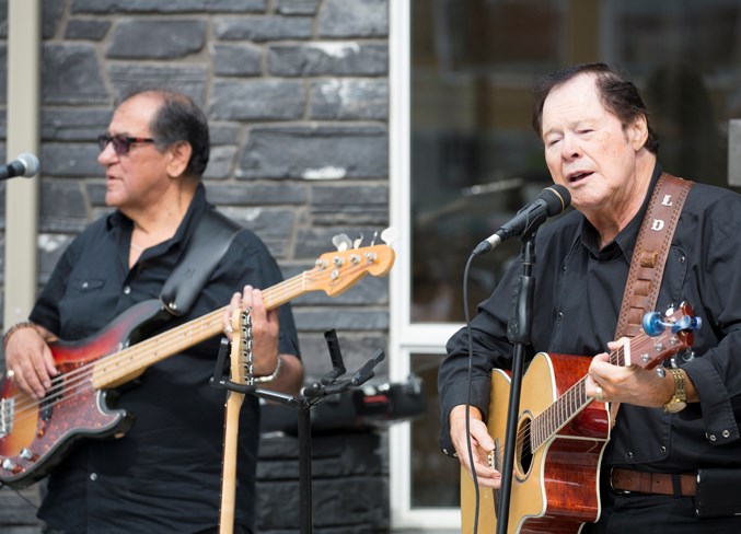  Leo Dumont, right, performs alongside Billy Joseph during the car show.