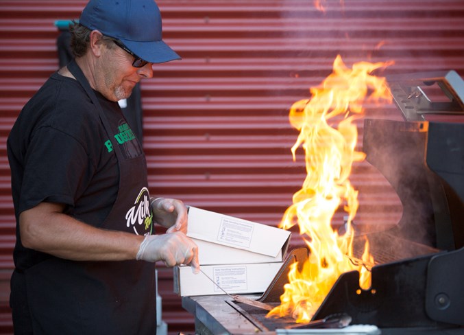  Murray Matchett grills some burgers on Sept. 5 during the annual welcome back barbecue and community registration event at River Valley School.