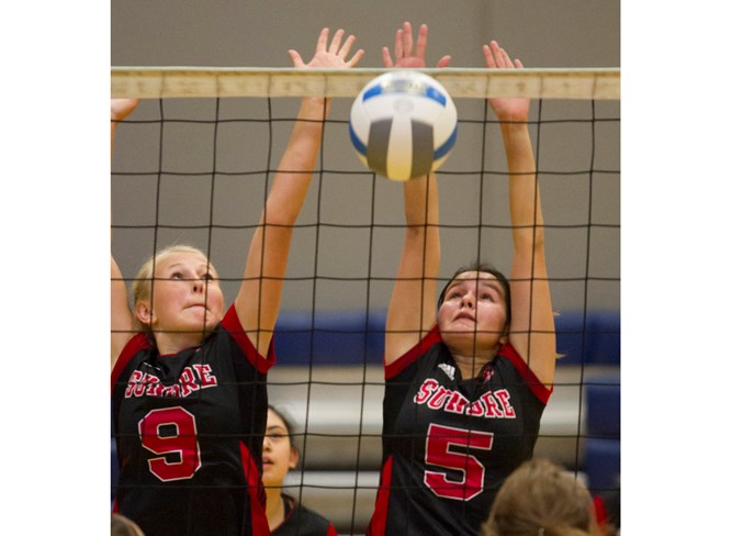 Sundre High School Scorpions players Taya Young, left, and Hailey Purcha attempt to block a shot during the Scorpions' game against SCHS at Hugh Sutherland School in Carstairs on Sept. 21.
