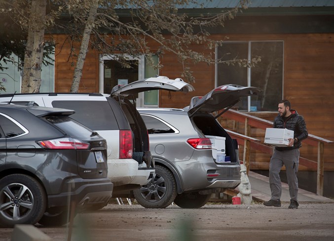  A man loads a box into a vehicle at the facility on Tuesday, Oct. 22.