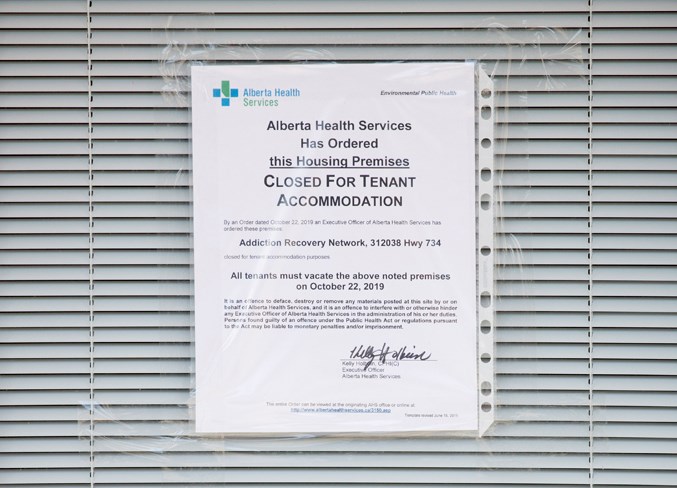  A sign from Alberta Health Services posted on a door declaring the order to close the facility.