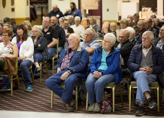  Attendees listen to the candidates answer questions during the forum.