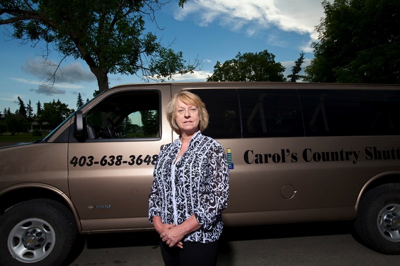 Carol James with her country shuttle next to Centennial Park in Olds.