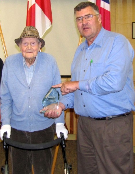 Jack Morgan receives a cut-glass statuette from Reeve Paddy Munro.