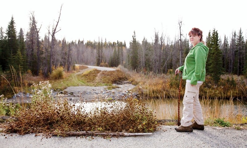 Diana Bouck at the site of the destroyed Big Prairie Bridge north of Water Valley. Bouck estimates she waited at least an extra 30 minutes while in life-threatening condition.