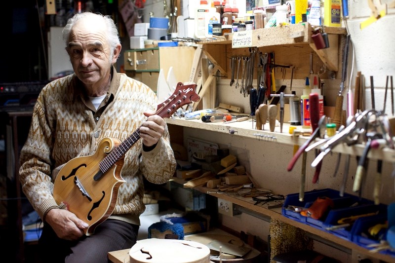 Nielson in his workshop with one of his mandolins.