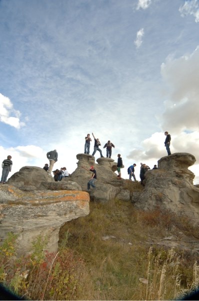 High school social studies students experience history for themselves studying the First Nation pictographs on rock formations near Carstairs.