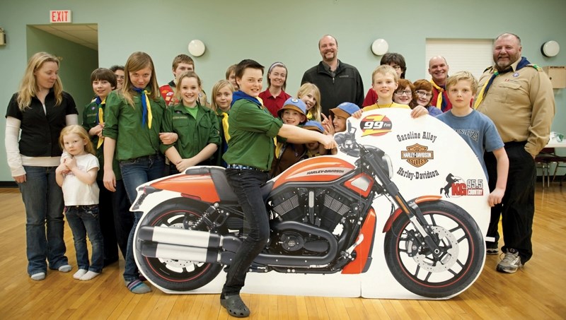 Don Larsen (back row) is bringing his cardboard cut-out Harley motorbike to as many events as possible in a bid to win a radio co&shy;ntest. At this meeting of the First Olds 