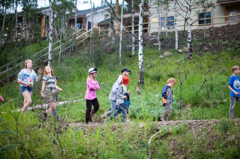 Campers head up to their cabins after the evening fire.
