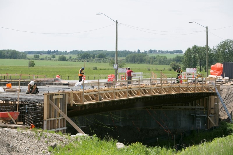 A construction crew works on a new bridge across the Dogpound creek on Highway 27. Construction on the project began in early summer 2016 and includes the installation of a
